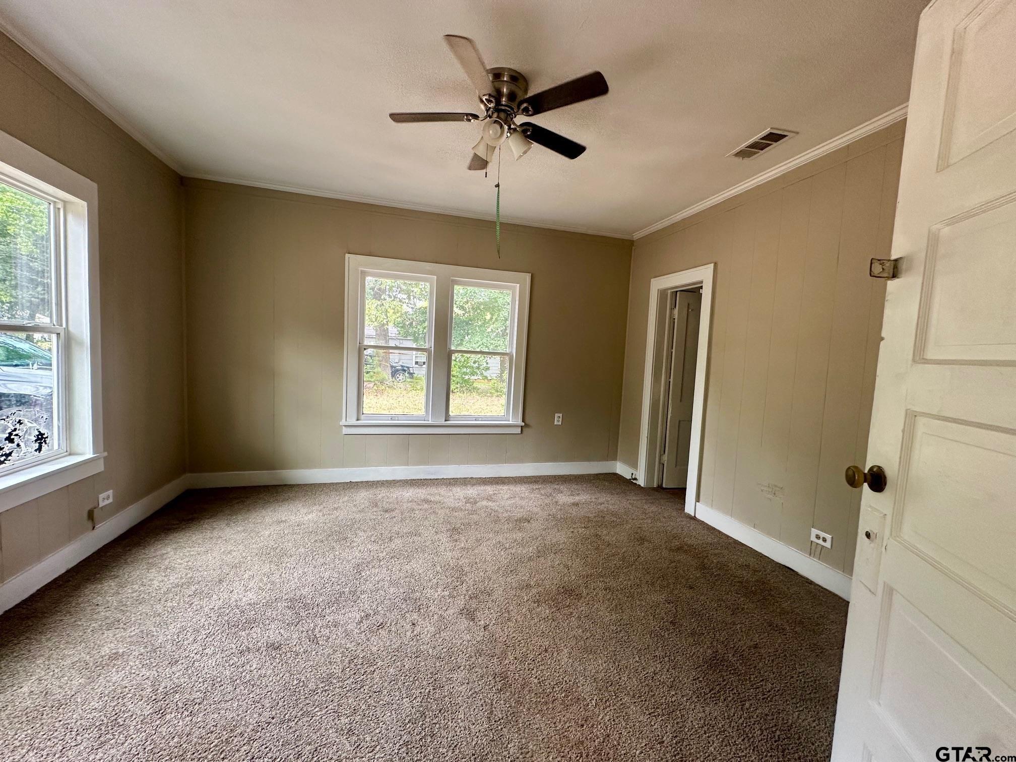1102 Myrtle Street Kilgore, TX 75662 - Photo 8 of 9 a view of an empty room with a window