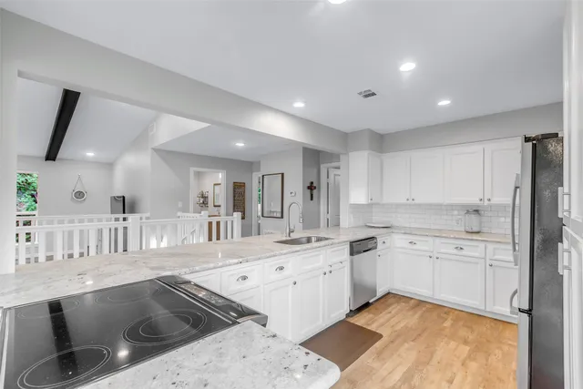 a kitchen with a sink stove and cabinets