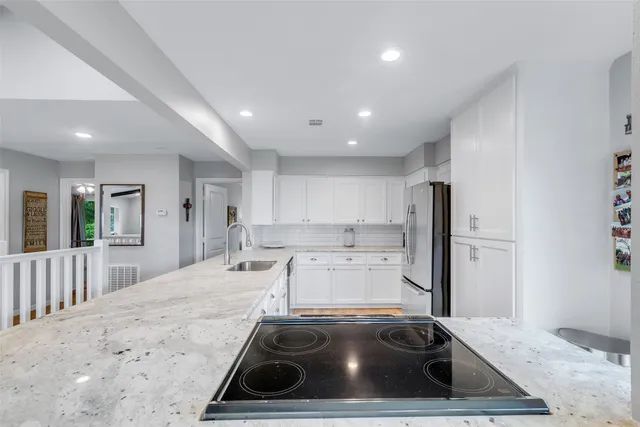 a kitchen with a sink stove and refrigerator