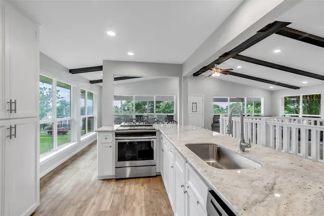 a kitchen with sink stove and refrigerator