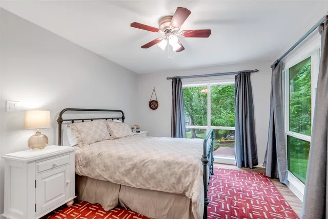 a bedroom with a bed and a large window