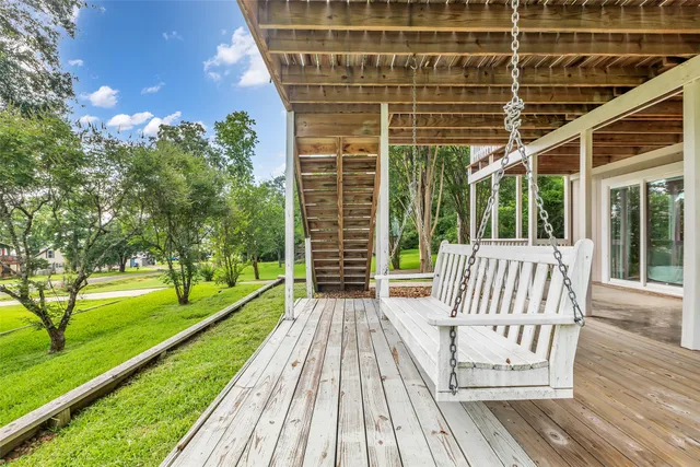 a view of a patio with a table chairs and a yard
