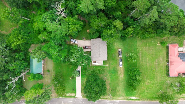 an aerial view of a house with a yard
