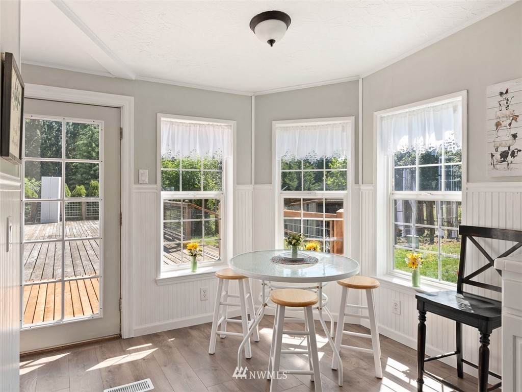 24226 Cromwell Road Monroe, WA 98272 - Photo 12 of 34 a dining room with wooden floor and windows
