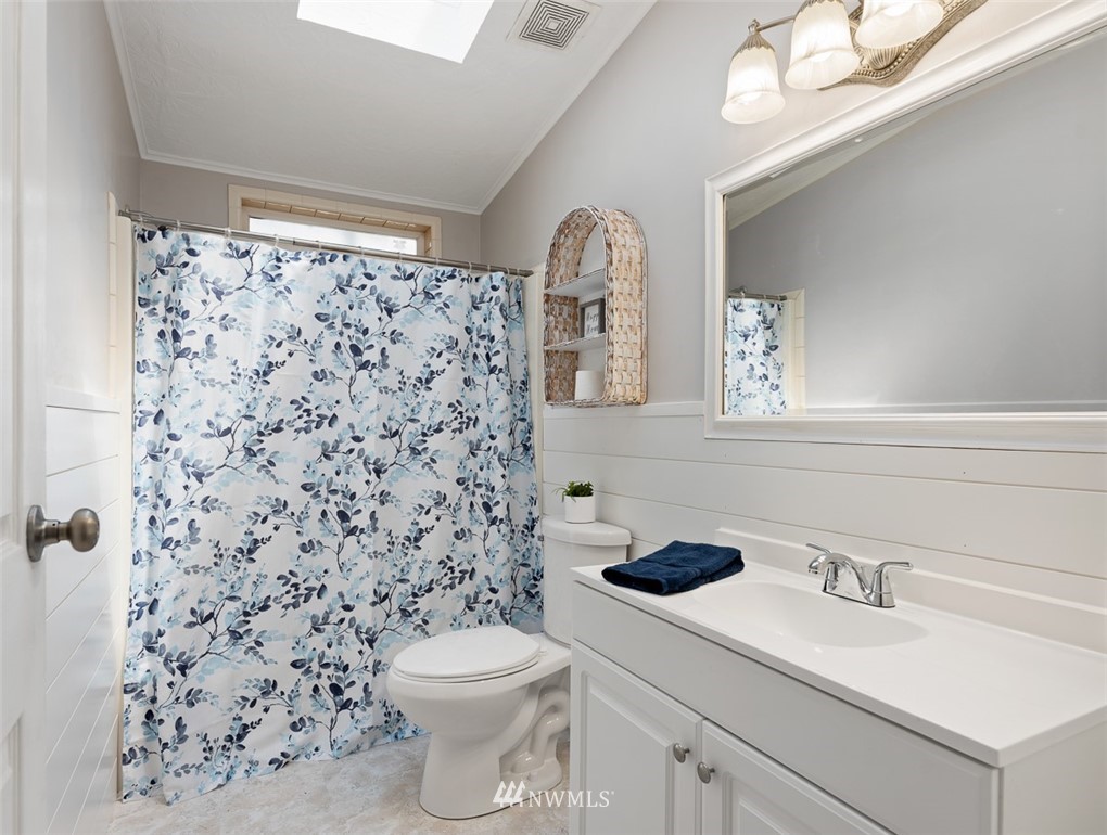 24226 Cromwell Road Monroe, WA 98272 - Photo 16 of 34 a bathroom with a sink a toilet and shower curtain