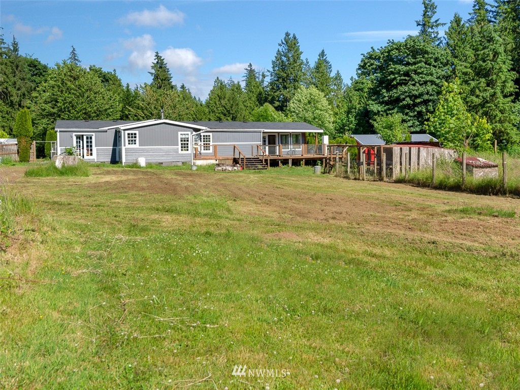 24226 Cromwell Road Monroe, WA 98272 - Photo 31 of 34 a front view of a house with a yard table and chairs