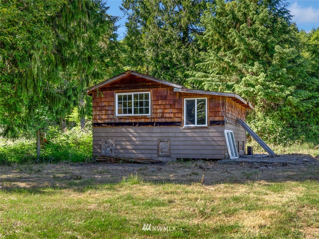 24226 Cromwell Road Monroe, WA 98272 - Photo 33 of 34 a front view of a house with a yard large trees and swimming pool