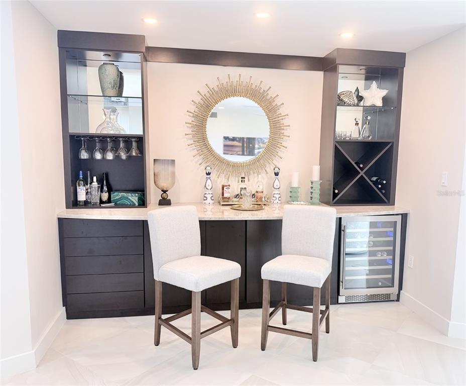 1050 Longboat Club Road, Unit 803 Longboat Key, FL 34228 - Photo 10 of 39 a room with a chair a mirror and a table