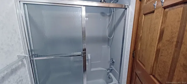 a bathroom with a glass shower door