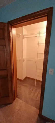 an empty room with wooden floor and sliding door