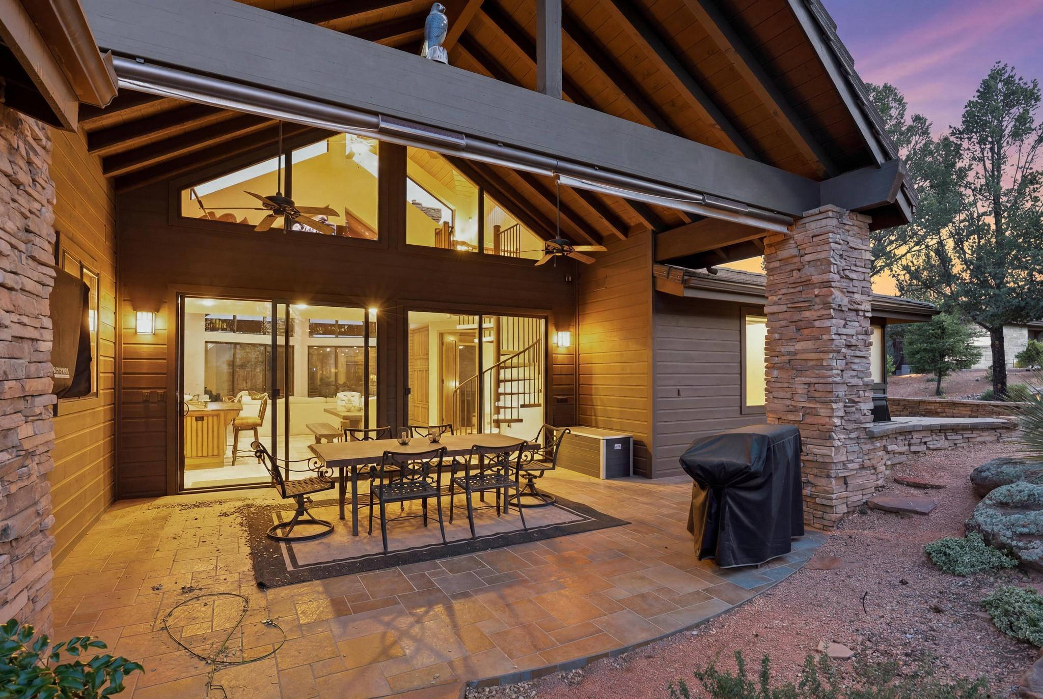 2908 East Rim Club Drive Payson, AZ 85541 - Photo 67 of 77 a view of a patio with table and chairs potted plants and floor to ceiling window