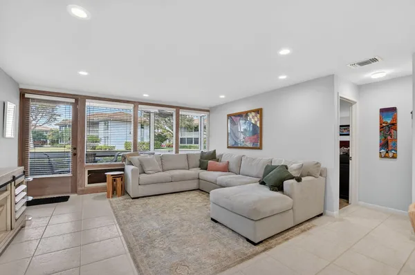 a living room with furniture and large windows