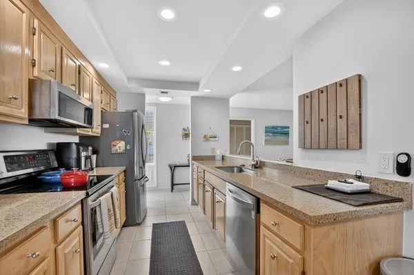 a kitchen with granite countertop a sink stove and cabinets