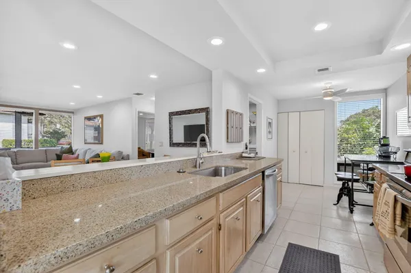 a large kitchen with stainless steel appliances granite countertop a lot of counter space and a sink