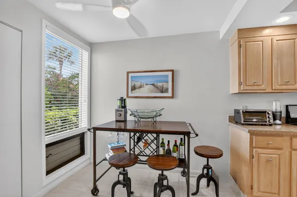 a table room with chairs and window