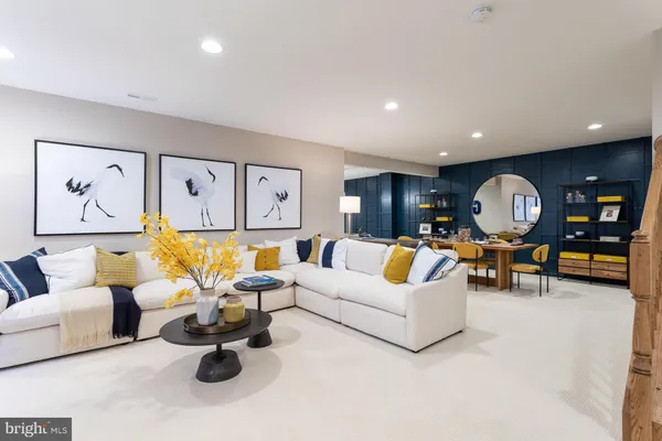 a living room with furniture kitchen view and a table