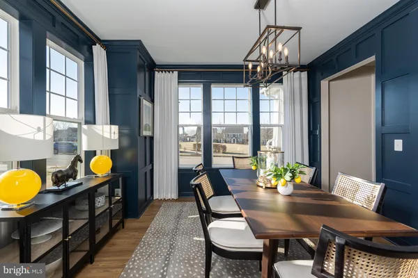 a view of a dining room with furniture and chandelier