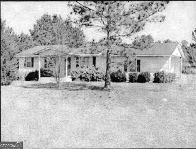398 Burketts Ferry Road Hazlehurst, GA 31539 - Photo 1 of 1 a view of a house with a yard covered in snow