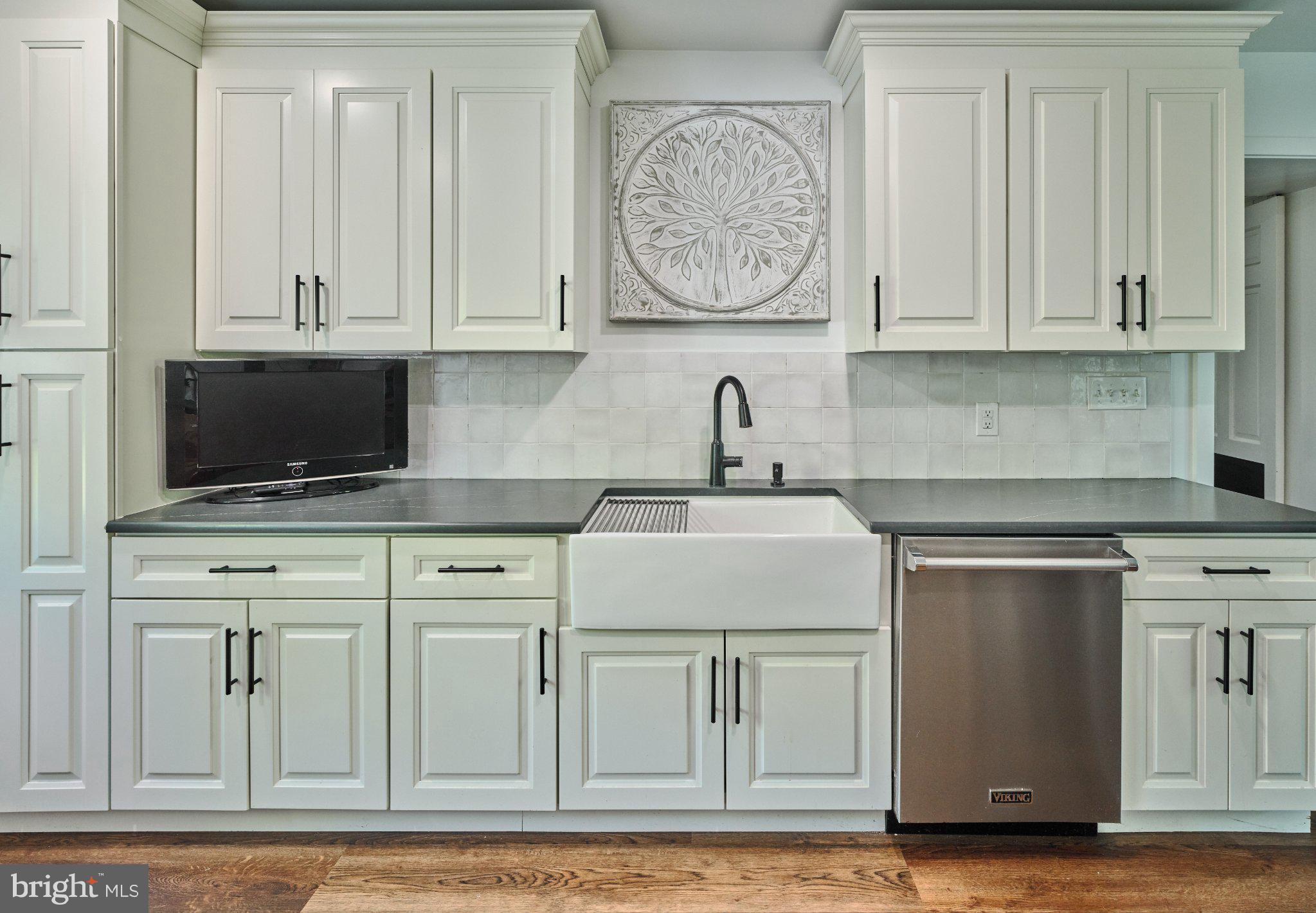 765 Swamp Road Newtown, PA 18940 - Photo 13 of 37 a kitchen with stainless steel appliances granite countertop a stove and a white cabinets