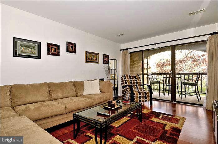 11204 Chestnut Grove Square, Unit 205 Reston, VA 20190 - Photo 9 of 25 Oversized Living Room with View of Patio
