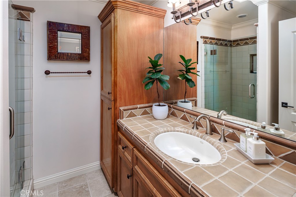 6400 San Gabriel Road Atascadero, CA 93422 - Photo 30 of 50 a bathroom with a granite countertop shower sink and mirror