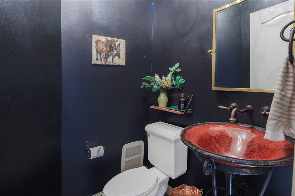 6400 San Gabriel Road Atascadero, CA 93422 - Photo 31 of 50 a bathroom with a toilet sink and mirror