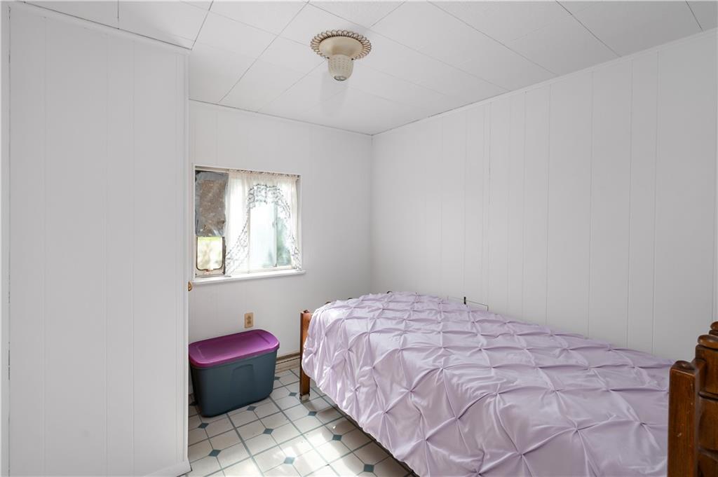 411 Harmony Road Baden, PA 15005 - Photo 14 of 25 a bedroom with a bed and a window