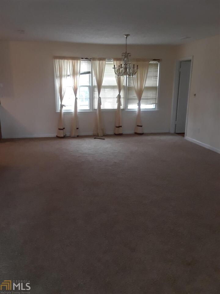 995 Green Street Southeast, Unit C Conyers, GA 30012 - Photo 13 of 29 an empty room with a empty space and windows