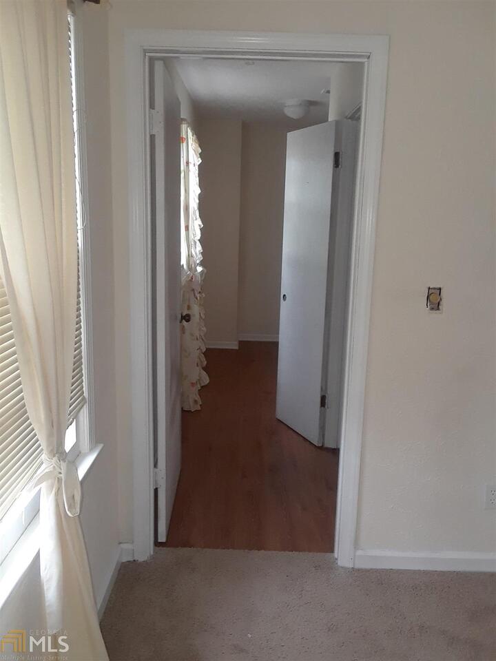 995 Green Street Southeast, Unit C Conyers, GA 30012 - Photo 17 of 29 a view of a livingroom from a hallway