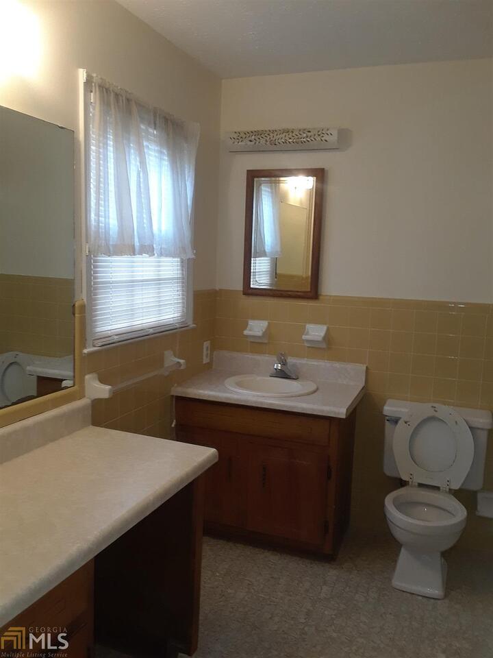 995 Green Street Southeast, Unit C Conyers, GA 30012 - Photo 21 of 29 a bathroom with a toilet sink and mirror