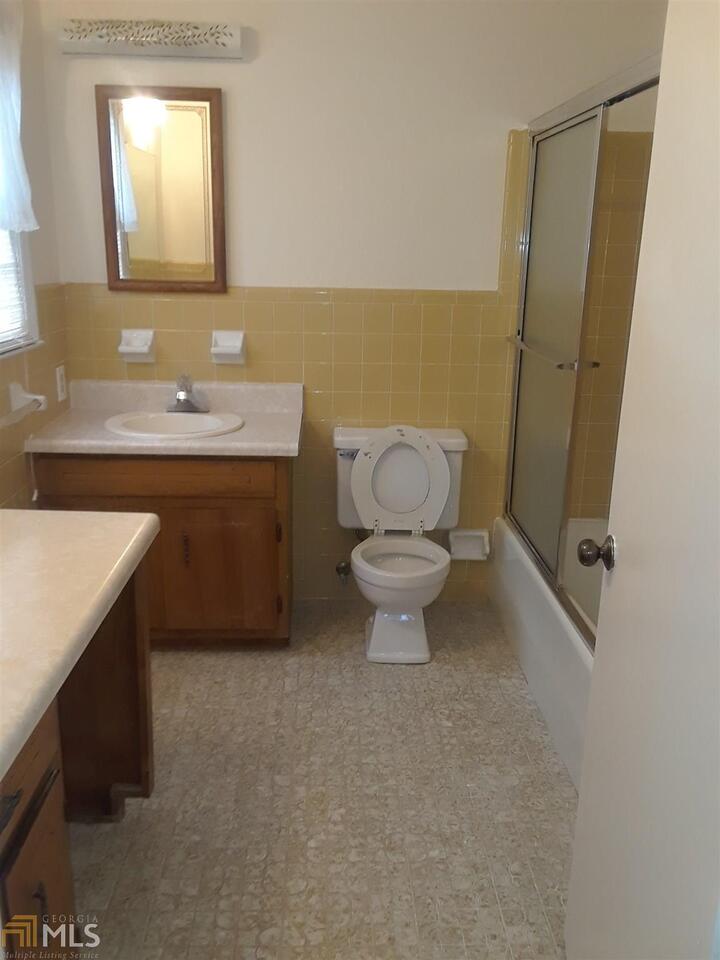 995 Green Street Southeast, Unit C Conyers, GA 30012 - Photo 22 of 29 a bathroom with a sink toilet and mirror
