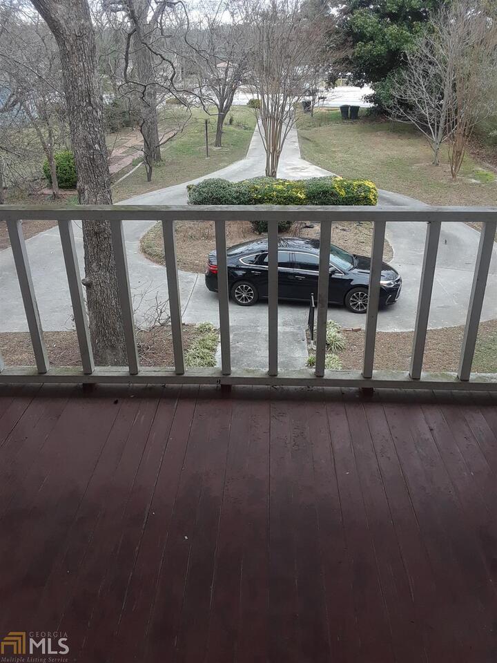 995 Green Street Southeast, Unit C Conyers, GA 30012 - Photo 24 of 29 a view of swimming pool with outdoor seating and lake in the background