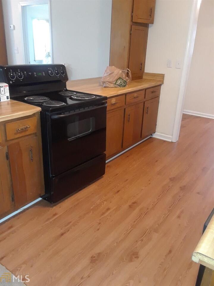 995 Green Street Southeast, Unit C Conyers, GA 30012 - Photo 9 of 29 a kitchen with a stove and a microwave