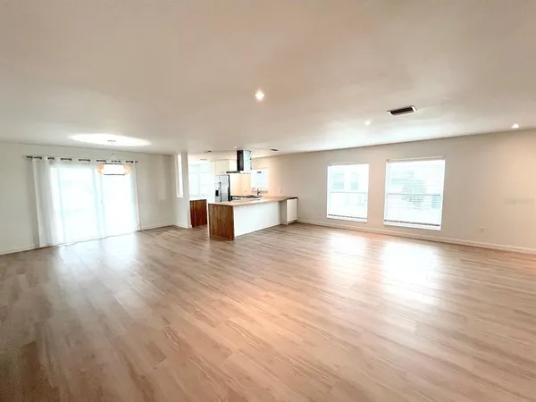 a view of a kitchen with a sink and a wooden floor