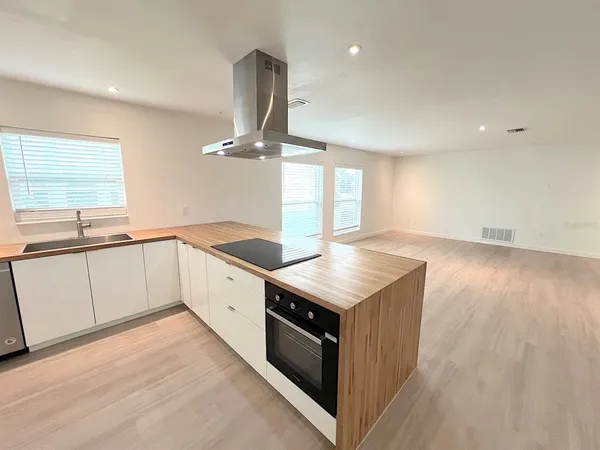 a room with a stove and wooden floor