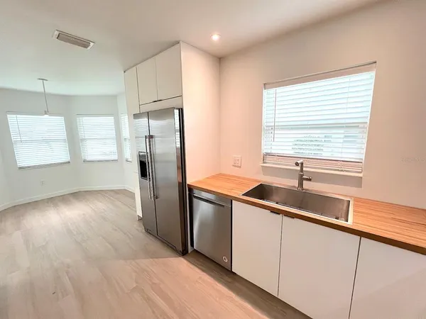 a kitchen with granite countertop white cabinets and white appliances