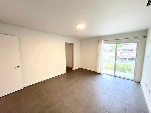 a spacious bathroom with a granite countertop sink and a mirror