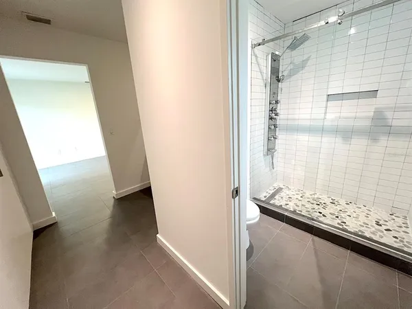 a bathroom with a toilet and shower