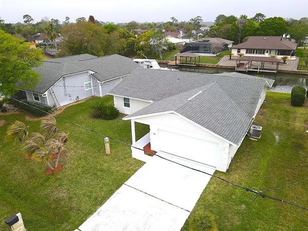 a view of a house with a yard and garage
