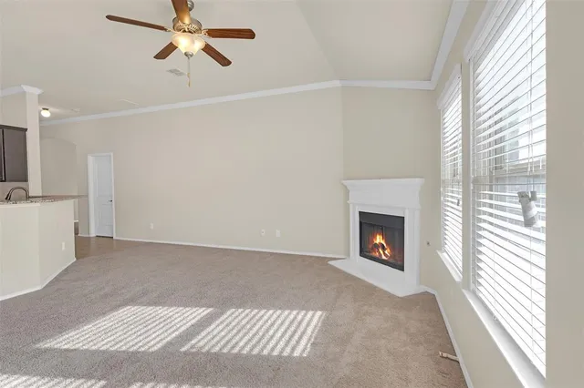 a view of a livingroom with a fireplace and windows