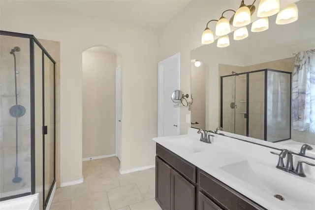 a bathroom with a double vanity sink and a mirror