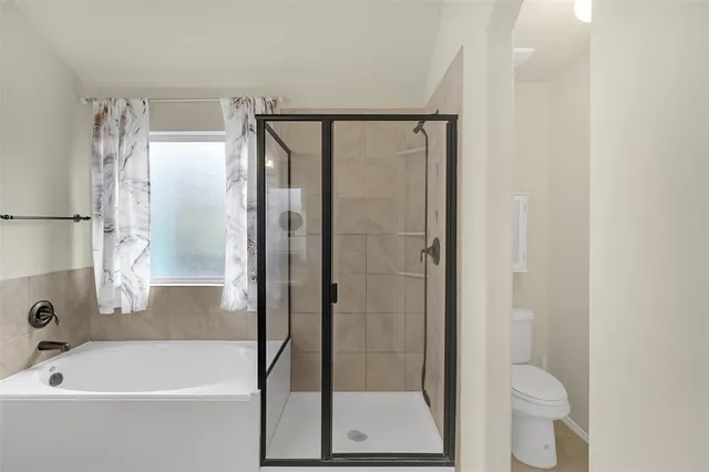 a bathroom with a bathtub and a shower