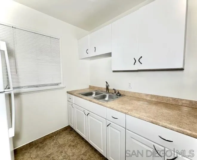 9747 Riverview Avenue, Unit 11 Lakeside, CA 92040 - Photo 2 of 6 a kitchen with a sink and cabinets