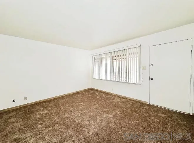 9747 Riverview Avenue, Unit 11 Lakeside, CA 92040 - Photo 3 of 6 a view of an empty room with a window