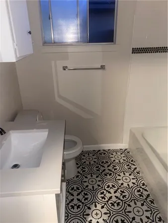 a bathroom with a toilet and a sink