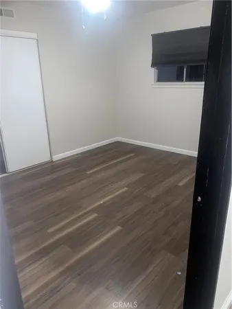 a view of a small space with wooden floor