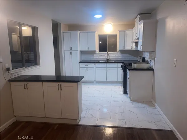 a kitchen with stainless steel appliances granite countertop a sink and cabinets