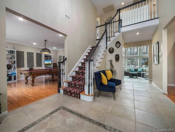 a living room with furniture and stairs