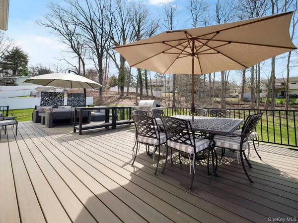 a view of a patio with couches and umbrella