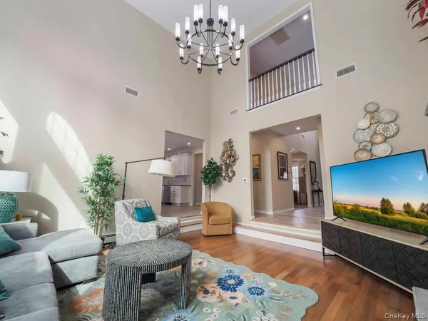a living room with furniture and a chandelier